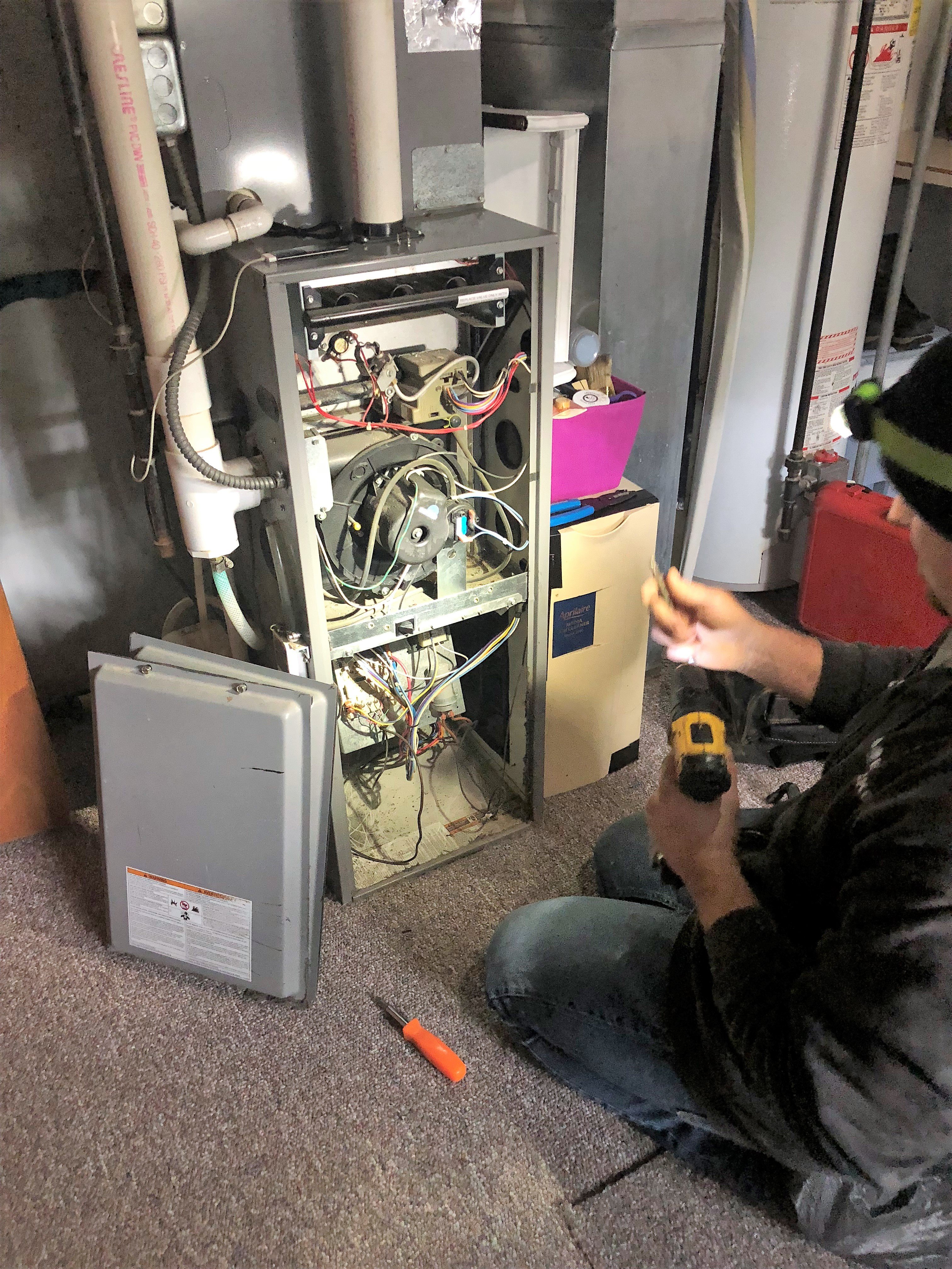 Technician servicing a furnace