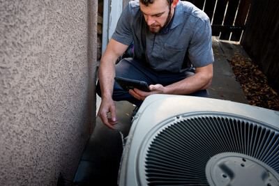 Technician servicing an air conditioner