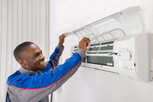 technician servicing ductless HVAC unit