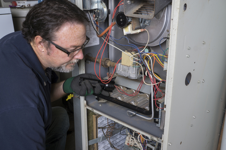 hvac tech servicing a system