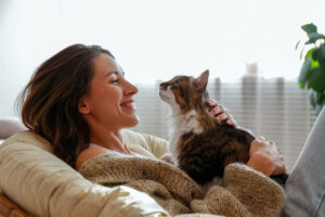 happy woman smiling and holding cat