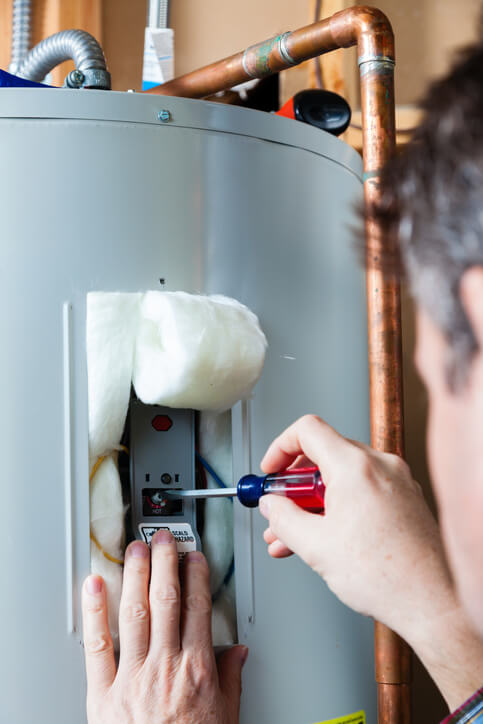 technician performing water heater maintenance