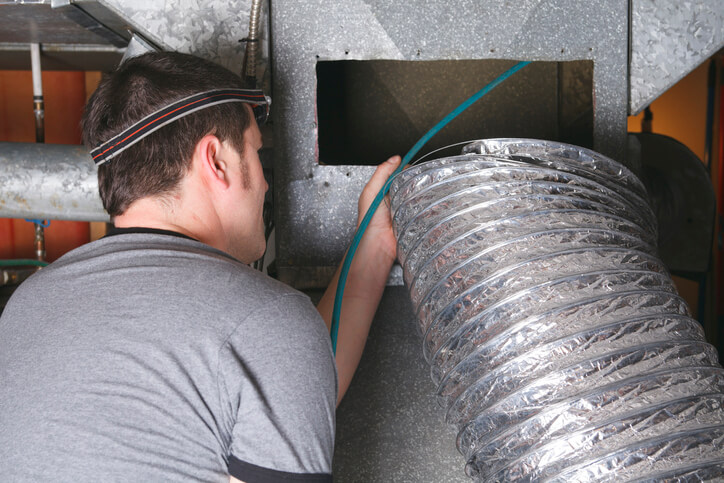 technician cleaning ducts