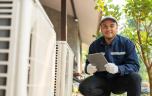 air conditioning technician checks system