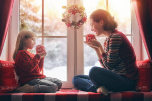 mother and her daughter enjoying hot tea