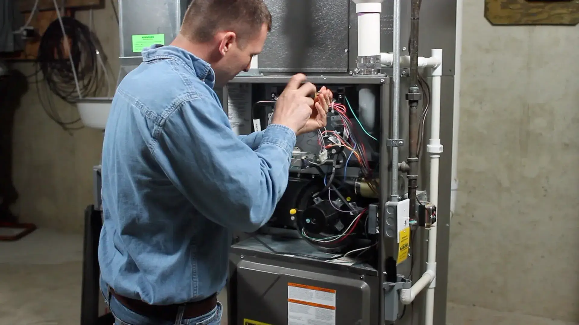 Technician servicing a furnace