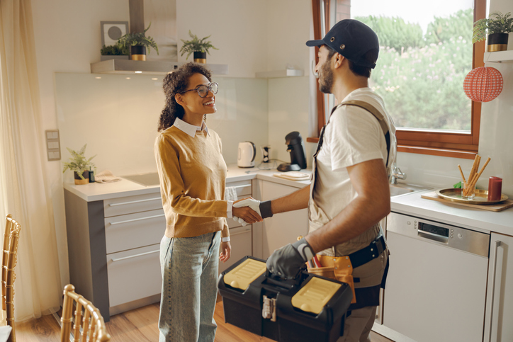 HVAC repairman shaking hands with a customer